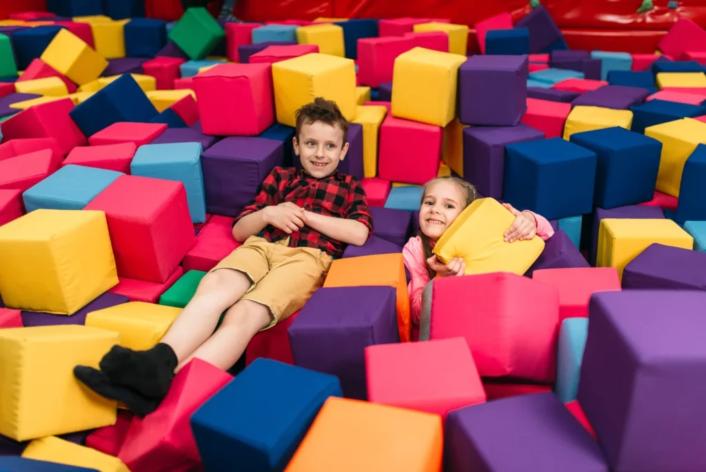 A secure childcare center with children playing safely, showcasing safety measures like secure entry points and staff supervising play areas