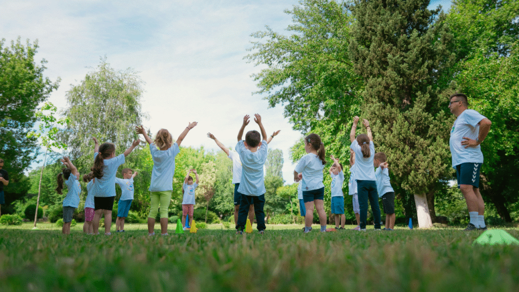 Children engaging in various types of play-based learning activities outdoors